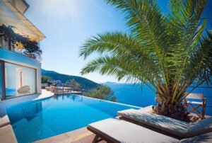 Swimming pool and beach chairs, on beachfront luxury villa