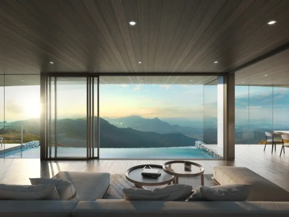 Luxury living room with panoramic view of mountains at sunset